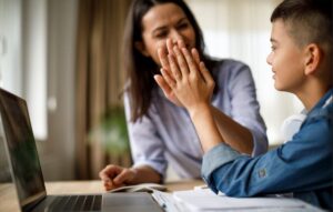 a woman and her son at a computer